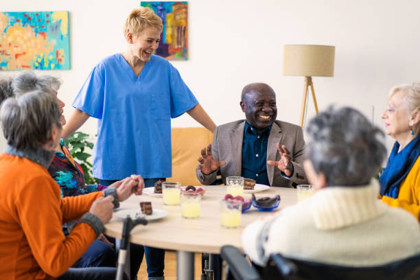 istock A friendly nurse chatting with retired pensioners 2148073224