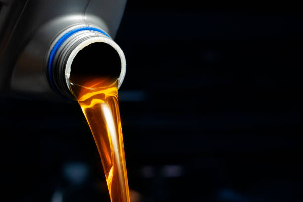 istock Pour engine oil from the lubricant bottle. Engine background, oil change shop engine service industry 2148074486