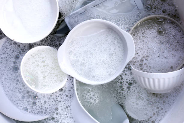istock Dish washing, Dirty dishes soaking in kitchen sink. 2148074534