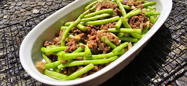 String green bean or french beans with minced beef stir fry or sauteed called Tumis buncis daging sapi cincang in Indonesia