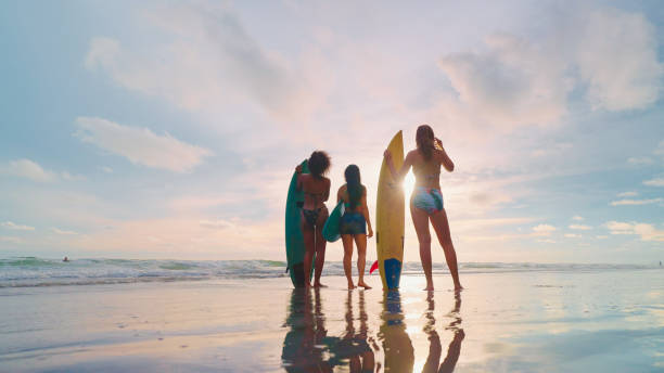 istock Friends surfing at the beach. 2148076450