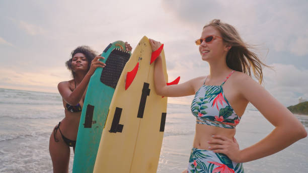 istock Friends surfing at the beach. 2148076723