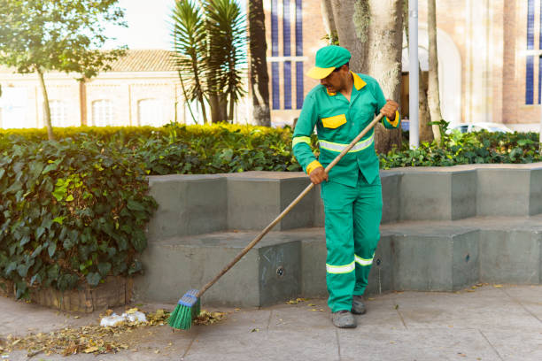 istock a man sweeping the park in the city 2148078307