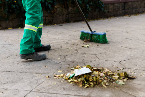 istock a municipal worker sweeping the dust in the park 2148078319