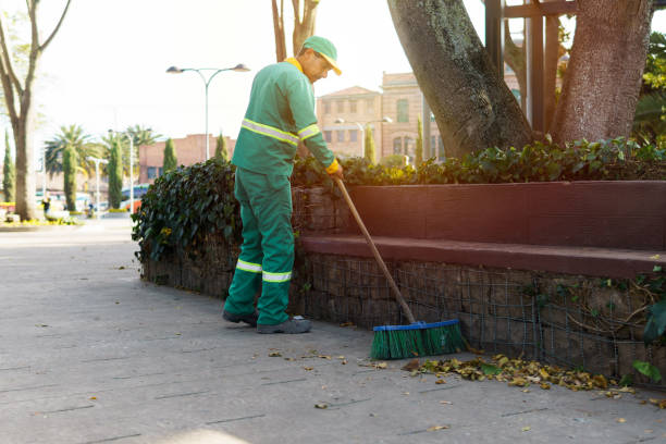 A street sweeper is sweeping the garbage found in a park