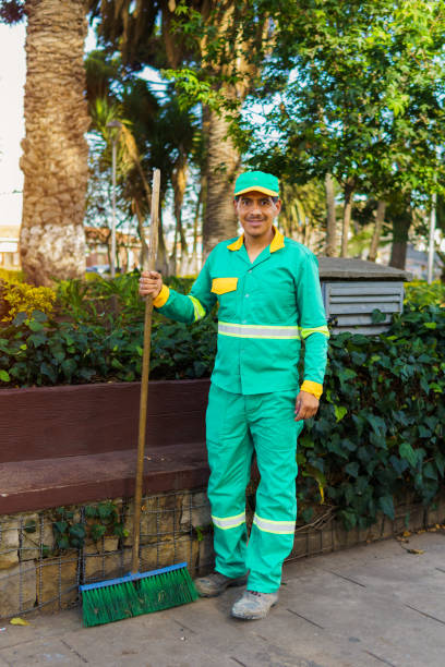 istock A dark-haired street sweeper standing in a park 2148078328