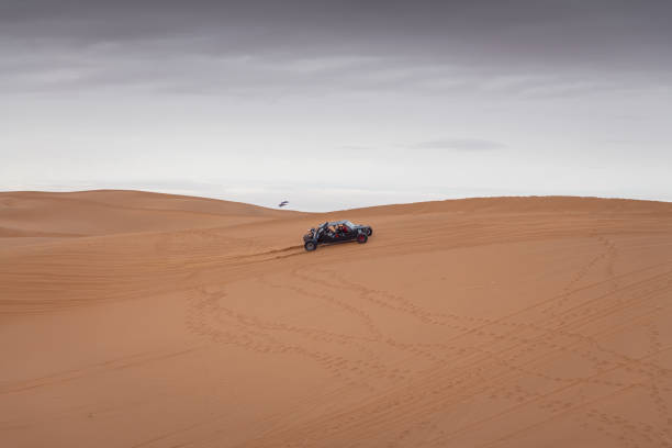 The car going through the Gobi desert in Inner Mongolia, China. Cloudy sky with copy space for text