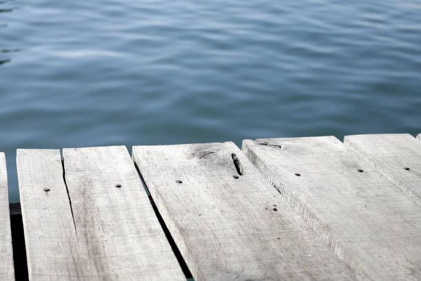 istock Wooden boardwalk with blue sea 2148078487