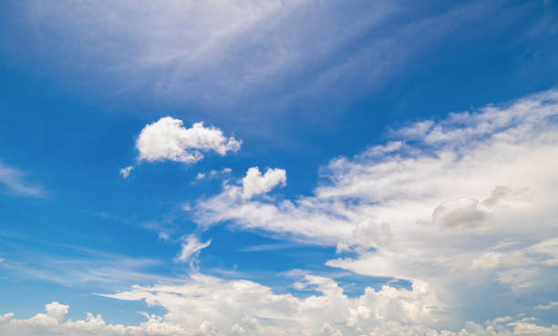 istock Panoramic view of clear blue sky and clouds, Blue sky background with tiny clouds. White fluffy clouds in the blue sky. Captivating stock photo featuring the mesmerizing beauty of the sky and clouds. 2148078531