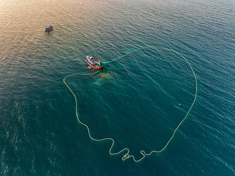 Drone view a fishing boat is netting fishes on  Nha Trang sea - Nha Trang city, Khanh Hoa province, central Vietnam