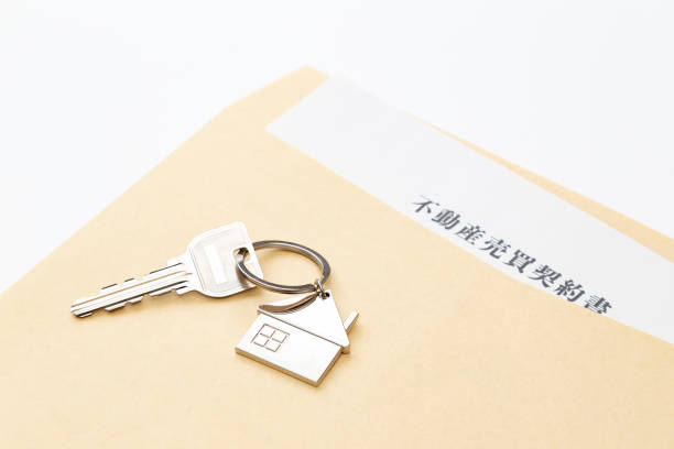 istock Real estate sales contract and keys on white background 2148081375