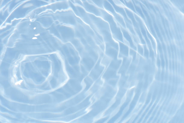 istock Bluewater waves on the surface ripples blurred. Defocus blurred transparent blue colored clear calm water surface texture with splash and bubbles. Water waves with shining pattern texture background. 2148081453
