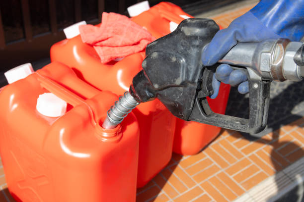 istock Refueling a red polyethylene tank with kerosene. 2148082378