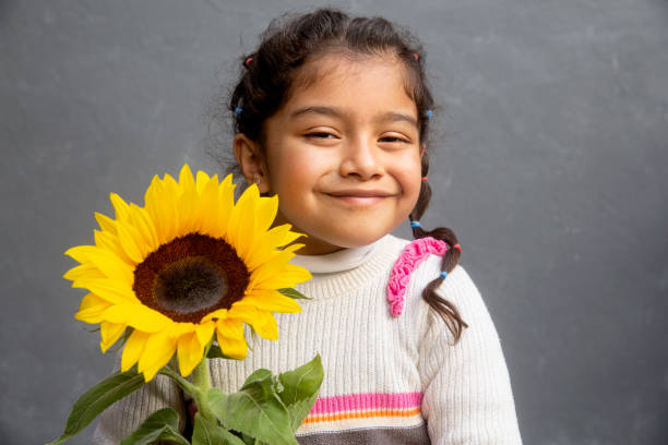 Little girl in sunflower field
