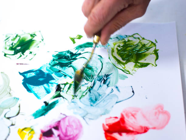 istock Artist's Hand Mixing Paints on Palette 2148087735