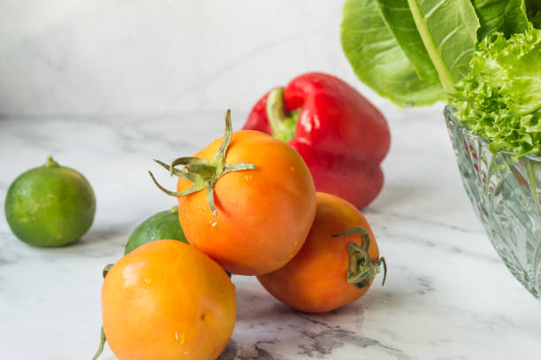 Fresh orange tomatoes and red bell peppers vegetable salad ingredients