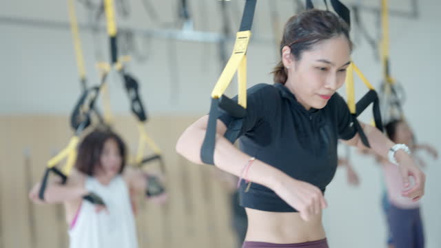 A woman is exercising with a group of people