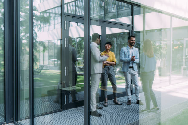 Business people talking outside of office building.