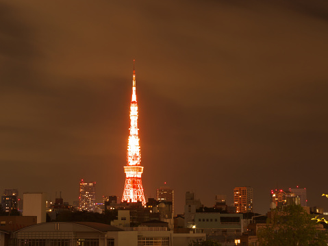 Tokyo night cityscape with illuminated tv tower glowing bright