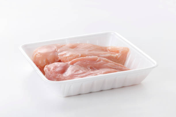 istock Raw Chicken breast on a foam tray on a white background 2148094655