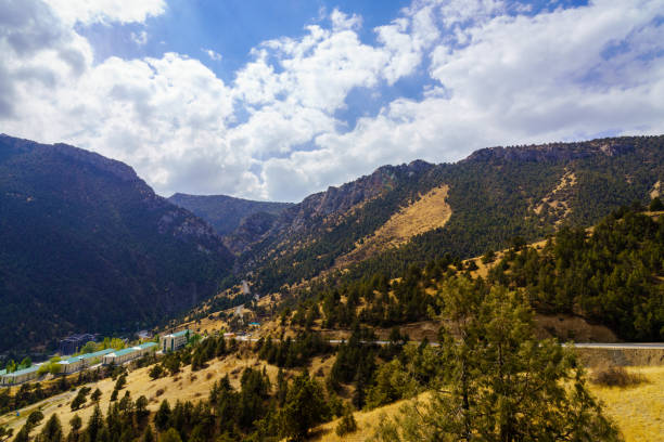 istock Mountains covered with grass and trees and cloudy dramatic sky on a daytime in Zaamin reserve. 2148095495