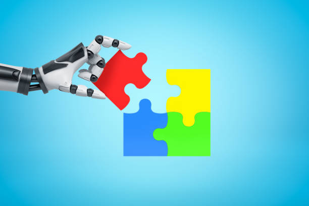 istock Robotic hand with colorful puzzle pieces on blue background 2148095755