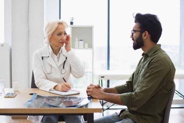 istock Elder physician giving recommendations using notebook for writing prescription. 2148096175