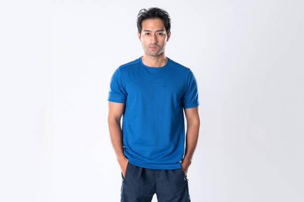 Elegant young man in blue shirt standing on white background