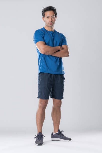 istock Elegant young man in blue shirt standing on white background 2148098551