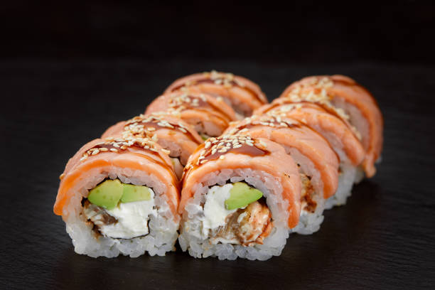 istock sushi roll with tuna, avocado and cream cheese on a black background. 2148098719
