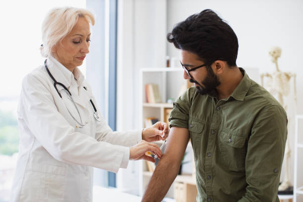 istock General practitioner giving injection to boost immunity for young patient. 2148098733