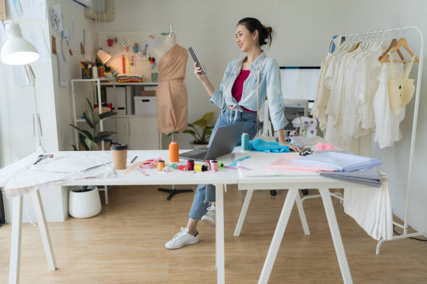 istock Female entrepreneur looking at tablet in tailoring studio. 2148098788