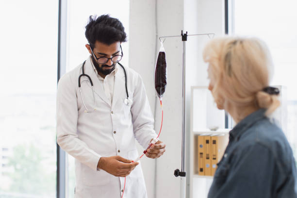 medical specialist checking system before procedure of patient in exam room. - iv pump imagens e fotografias de stock