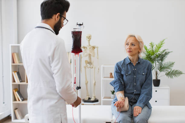 medical specialist checking system before procedure of patient in exam room. - iv pump imagens e fotografias de stock