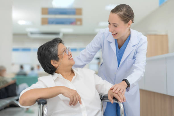 istock Doctor helping senior patient push wheelchair. 2148099084
