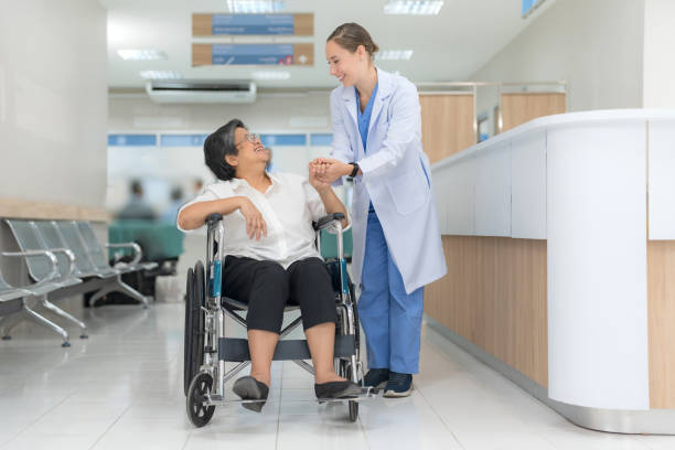 istock Doctor helping senior patient push wheelchair. 2148099341