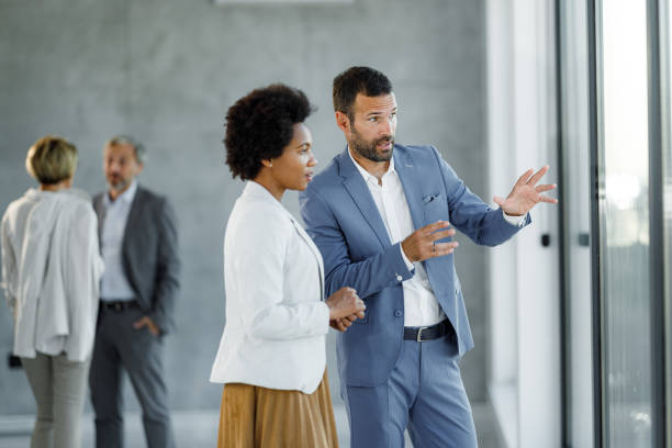 istock Business colleagues talking while looking through window from the office. 2148099677