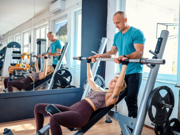 istock Young woman exercising with personal trainer 2148099750