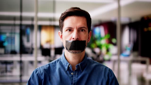 Young Man With Black Duct Tape Over His Mouth