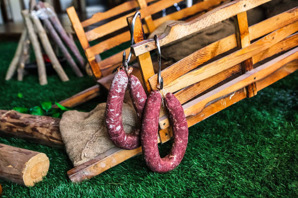 istock Sausages Hanging From Wooden Bench 2148101129