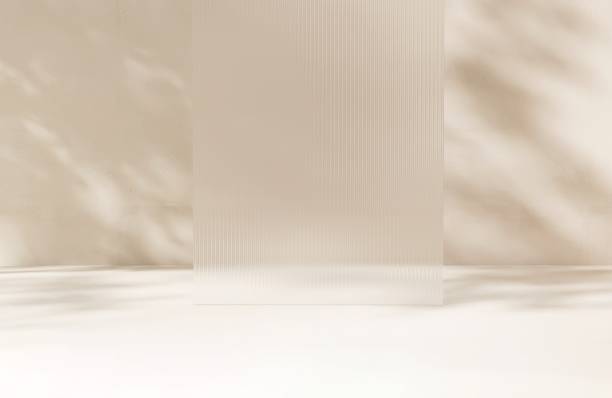 istock Clean fluted reeded glass in dappled sunlight, tree leaf shadow on white floor 2148101279