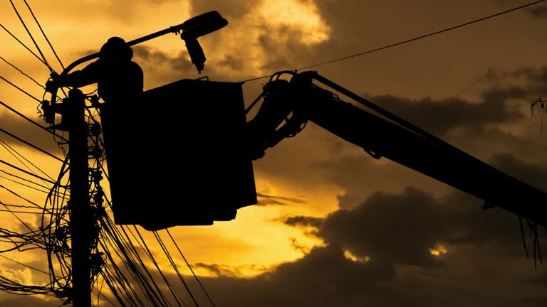 Silhouette of an electrician to repair street lighting