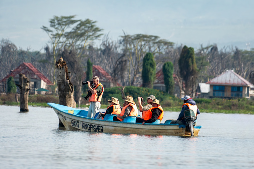 tourists sail by boat on Lake Naivasha. Water safari with viewing of animals and birds. Naivasha lake, Kenya. February 2, 2024.