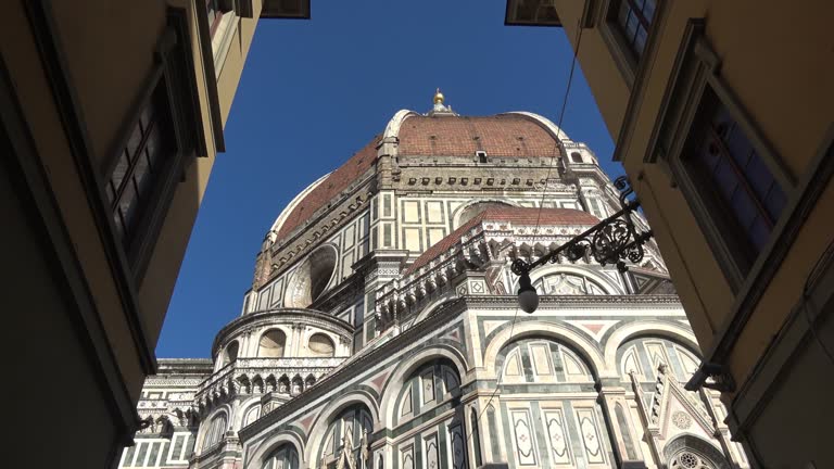 Florence, Italy, seen from below. Details of the cathedral and Giotto's bell tower. View of the Basilica of Santa Maria del Fiore. 4K footage