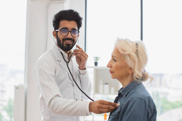 istock General practitioner, looking at camera, examining heartbeat while in clinic. 2148102266