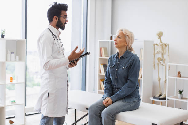 istock Adult bearded physician giving recommendations and using tablet. 2148102274