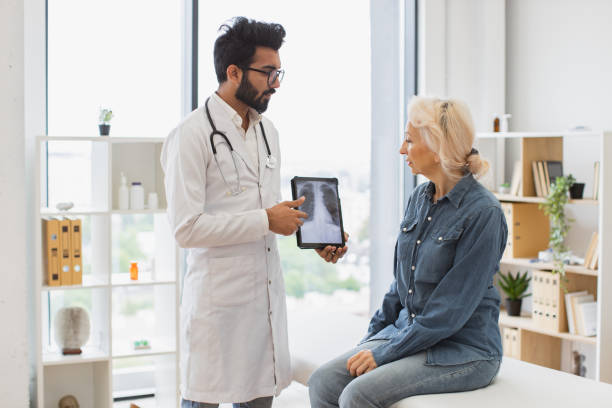istock Bearded male in lab coat holding tablet with MRI scan. 2148102277