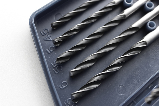 Part of set box for drill bits storage on white surface stock photo