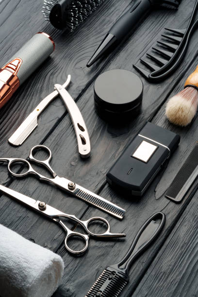 istock Professional Barber Tools Laid Out on Dark Wooden Surface 2148103119