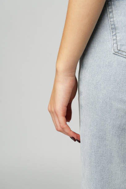 istock Close up of woman's hand against gray background in studio 2148103374